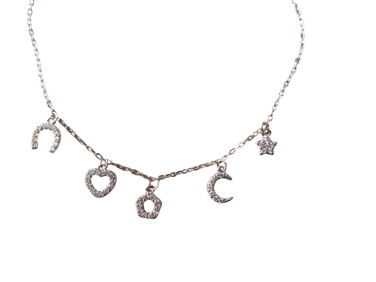 Pulsera con dijes de zirconias. Plata ley 925, acabado en Rodio